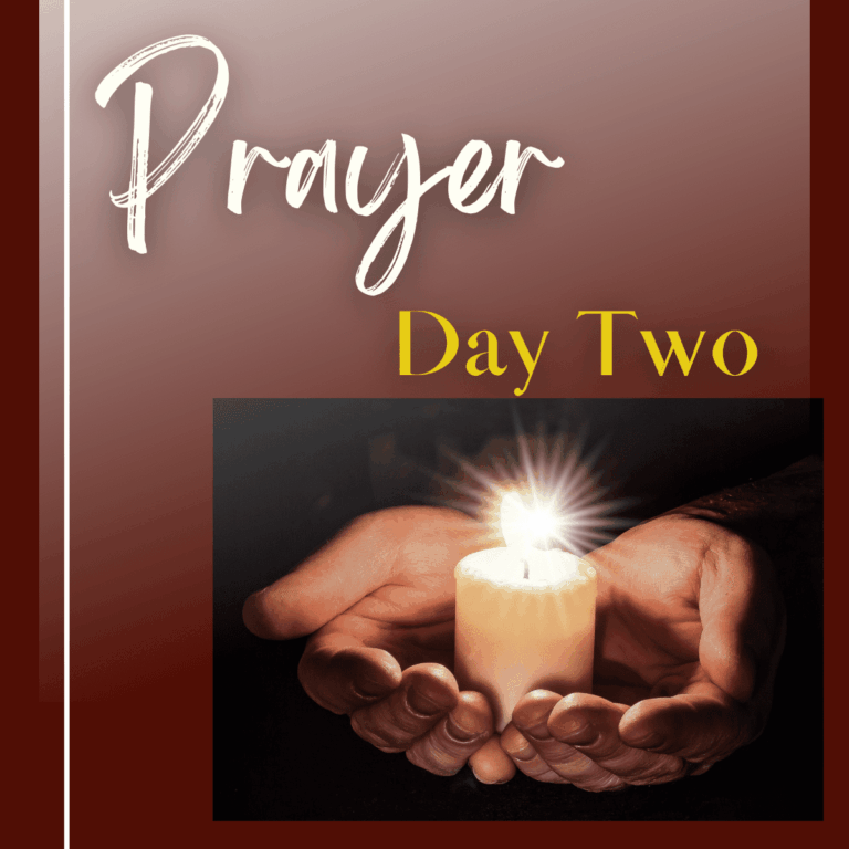 Hands holding lit candle to symbolize prayer